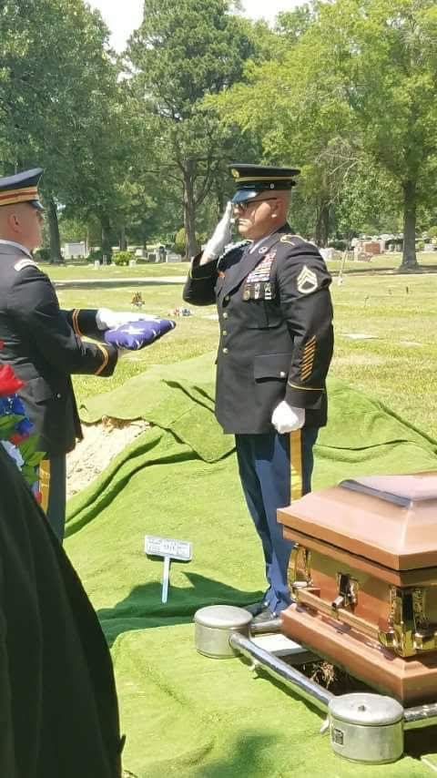 Military honor guard rendering final salute at the gravesite of a U.S. Army Vietnam veteran